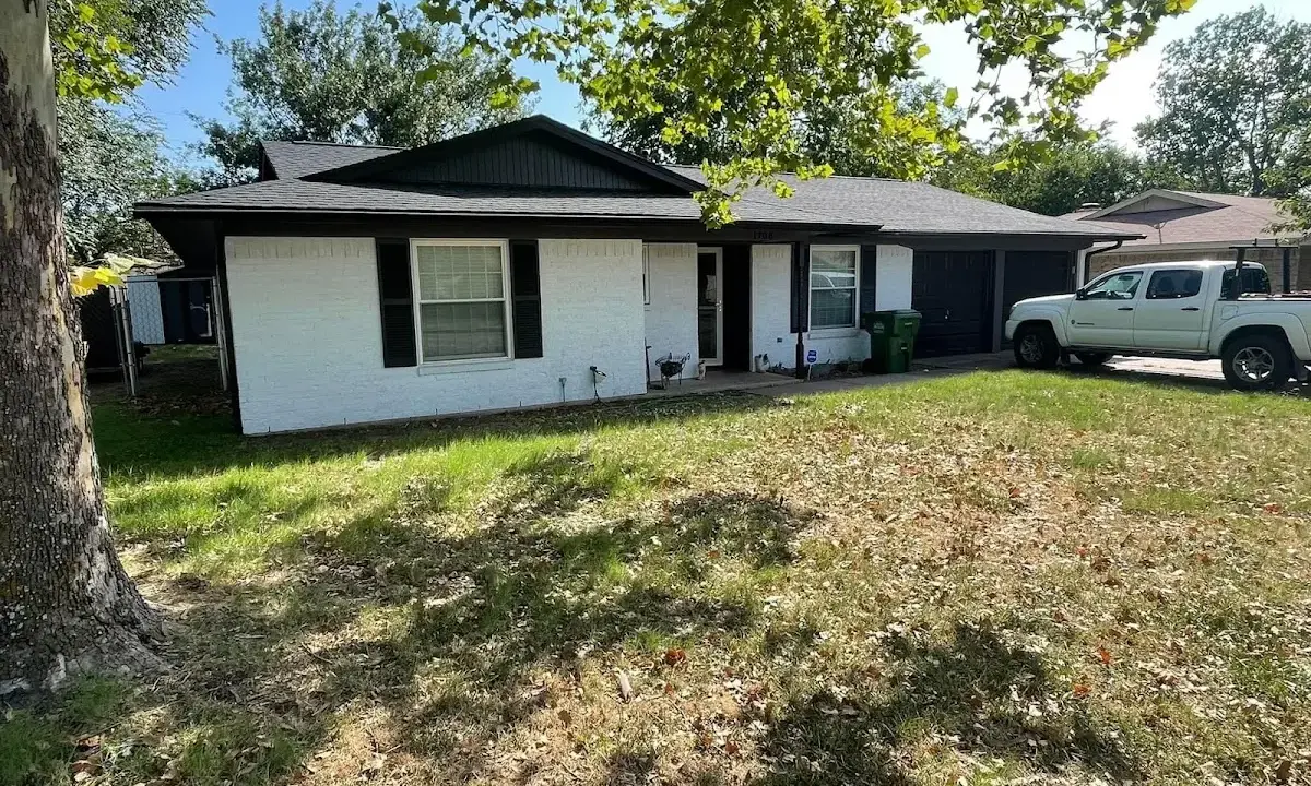 Professional roofing crew working on a residential roof in Albany